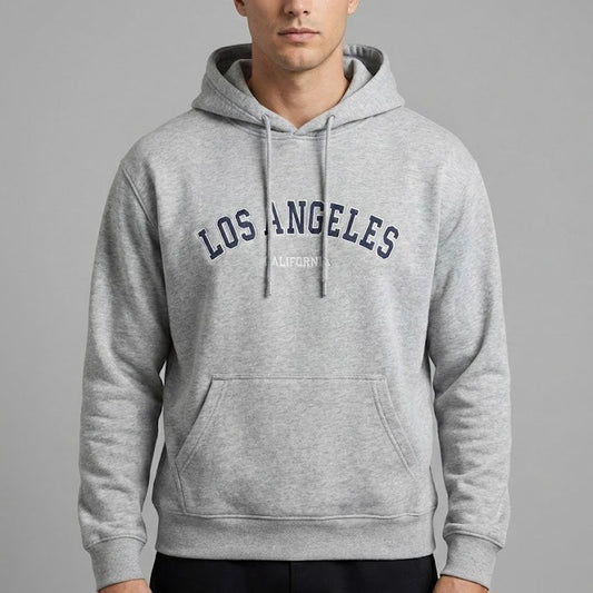 Man wearing a gray hoodie with 'Los Angeles' text on a gray background