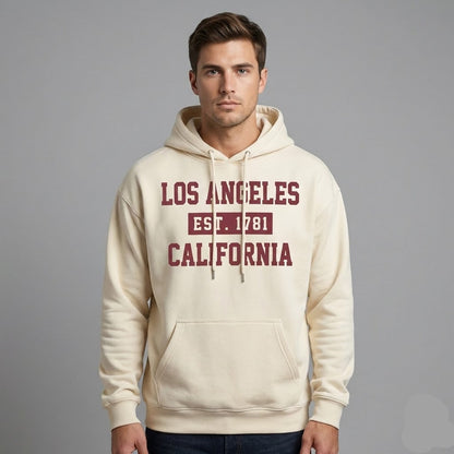 Man wearing a beige hoodie with 'Los Angeles Est. 1781 California' text on a gray background