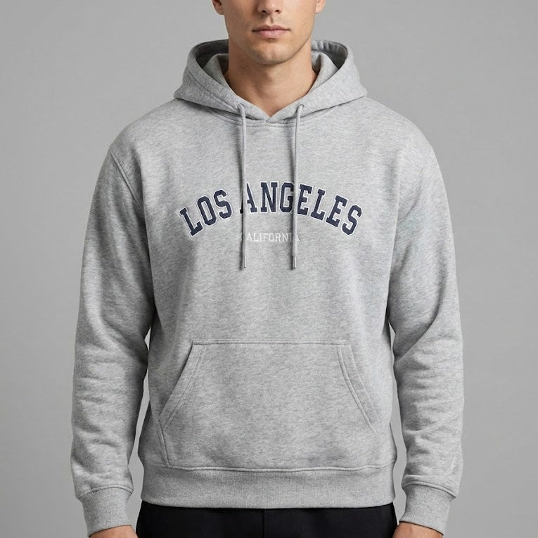 Man wearing a gray hoodie with 'Los Angeles' text on a gray background
